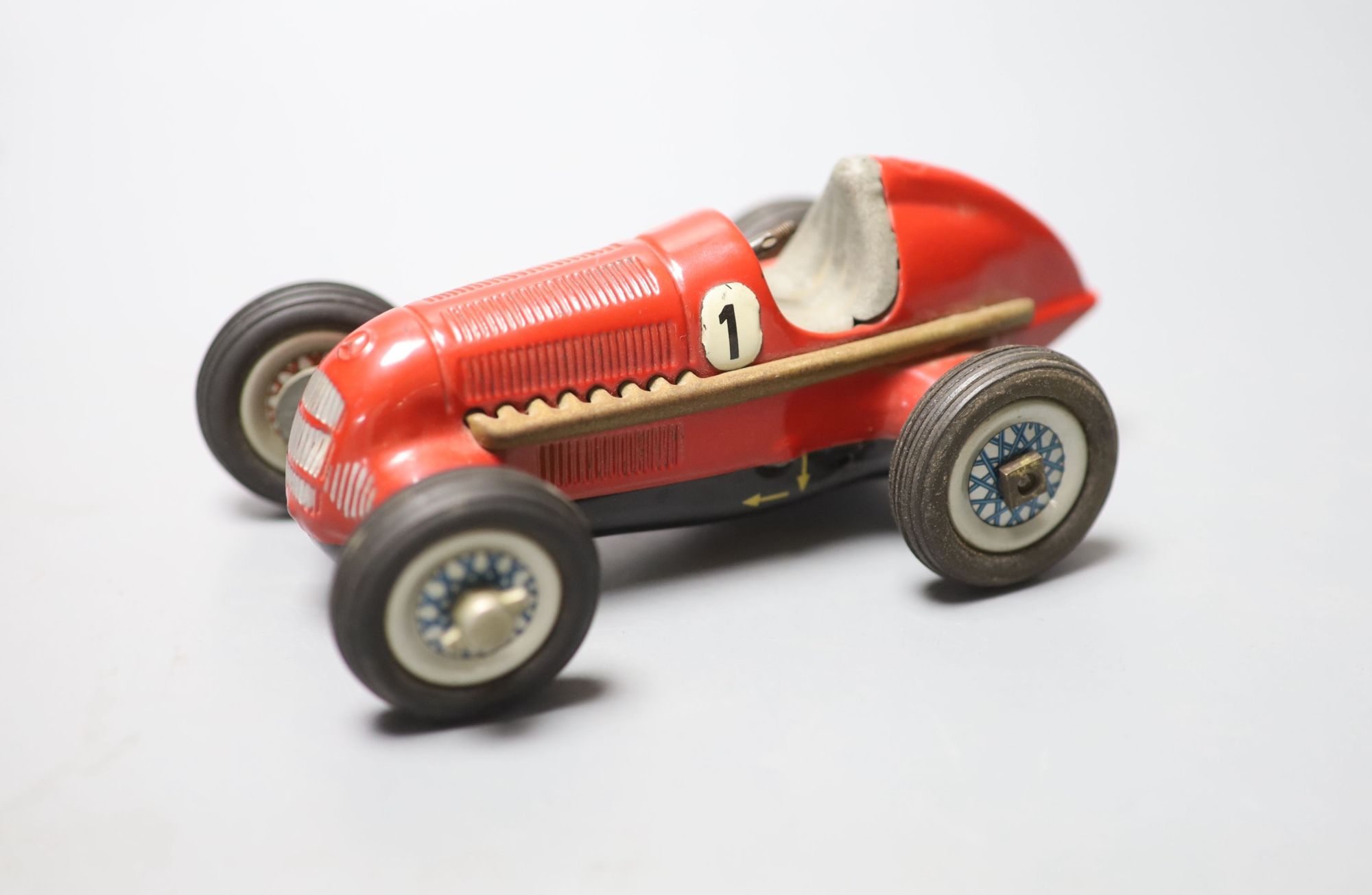 A Schuco Studio 1050 clockwork Mercedes racing car in red, length 14cm